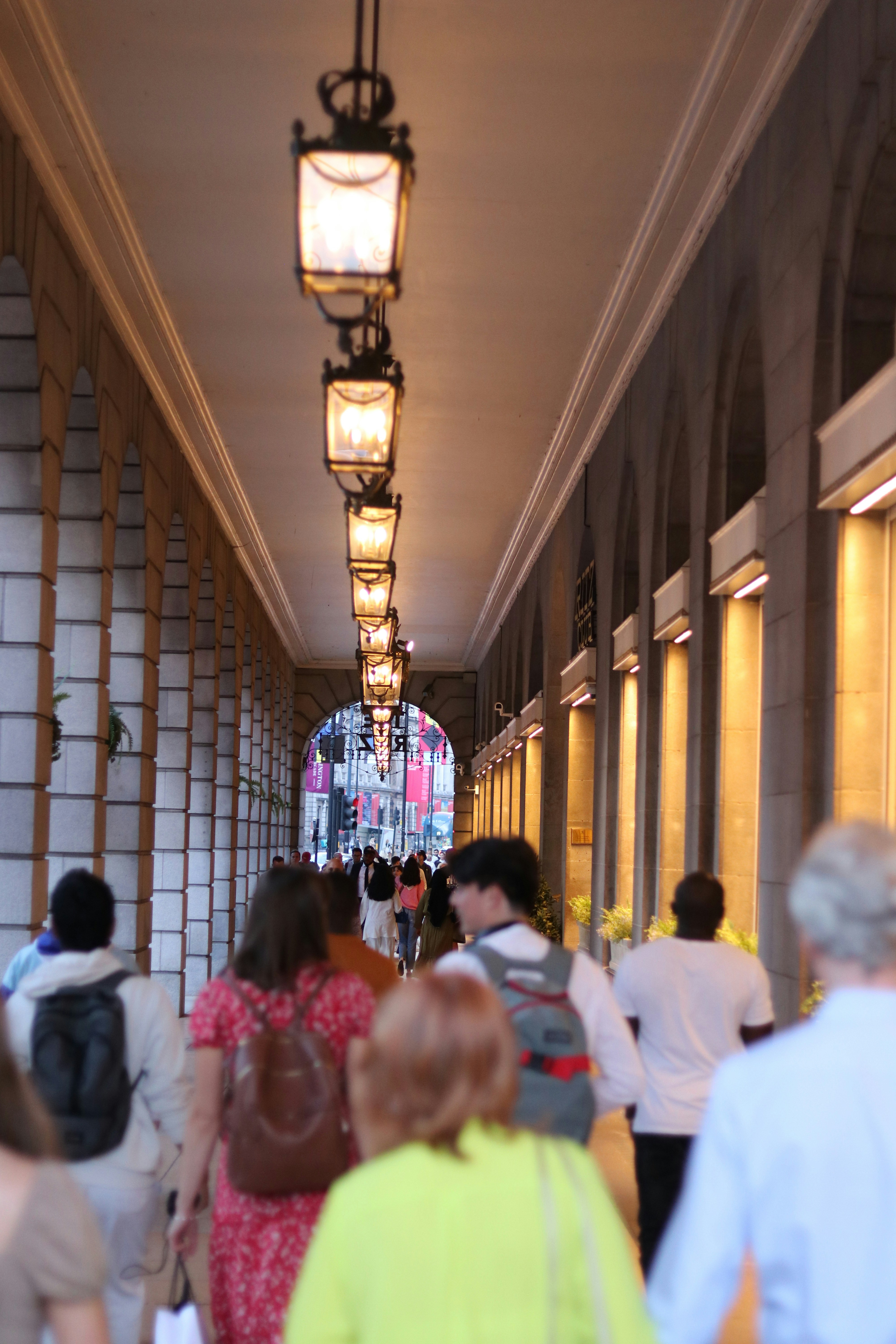 a group of people walking down a long hallway