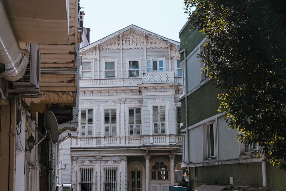 a white house with white shutters on a street