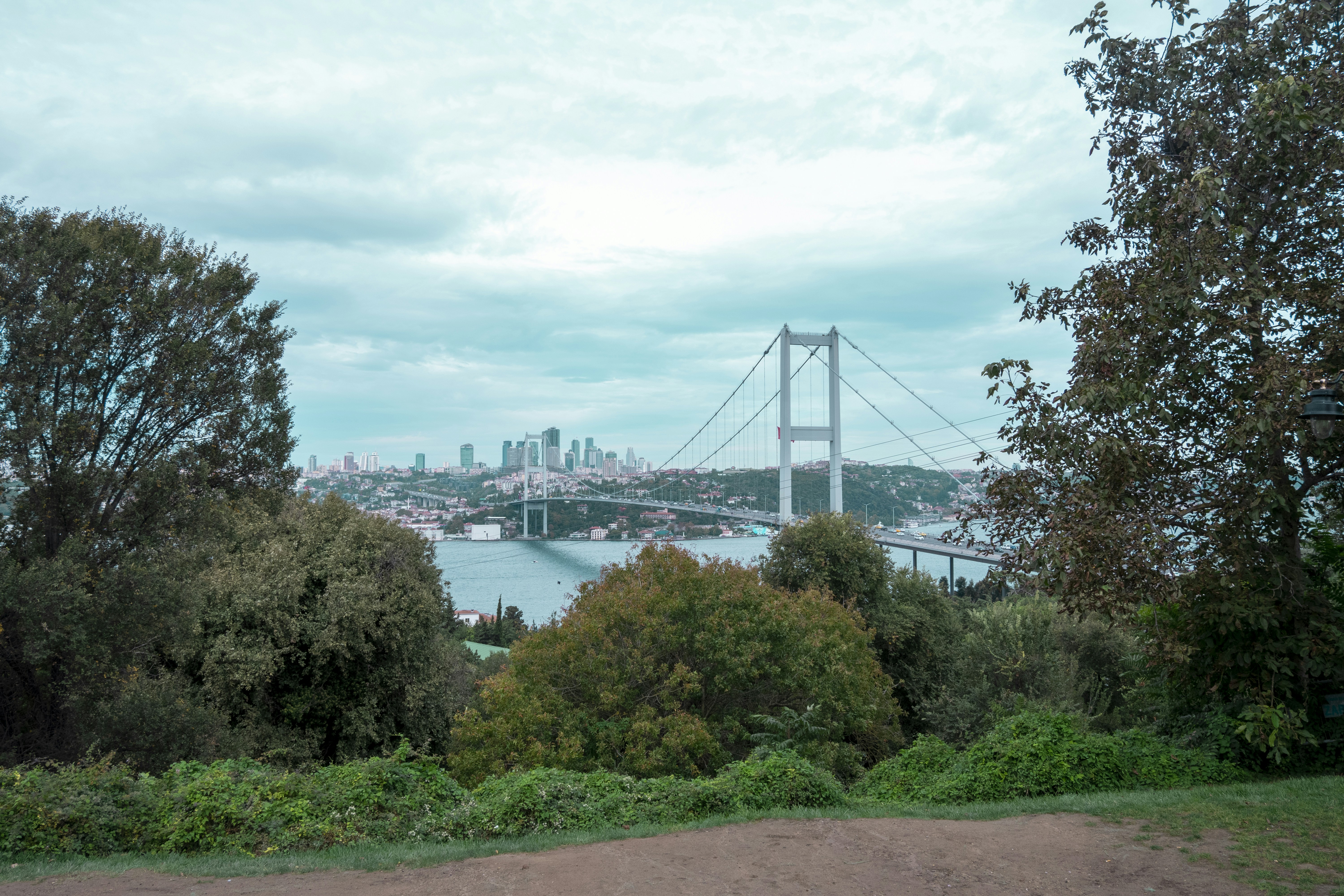 a view of a bridge over a river with a city in the background
