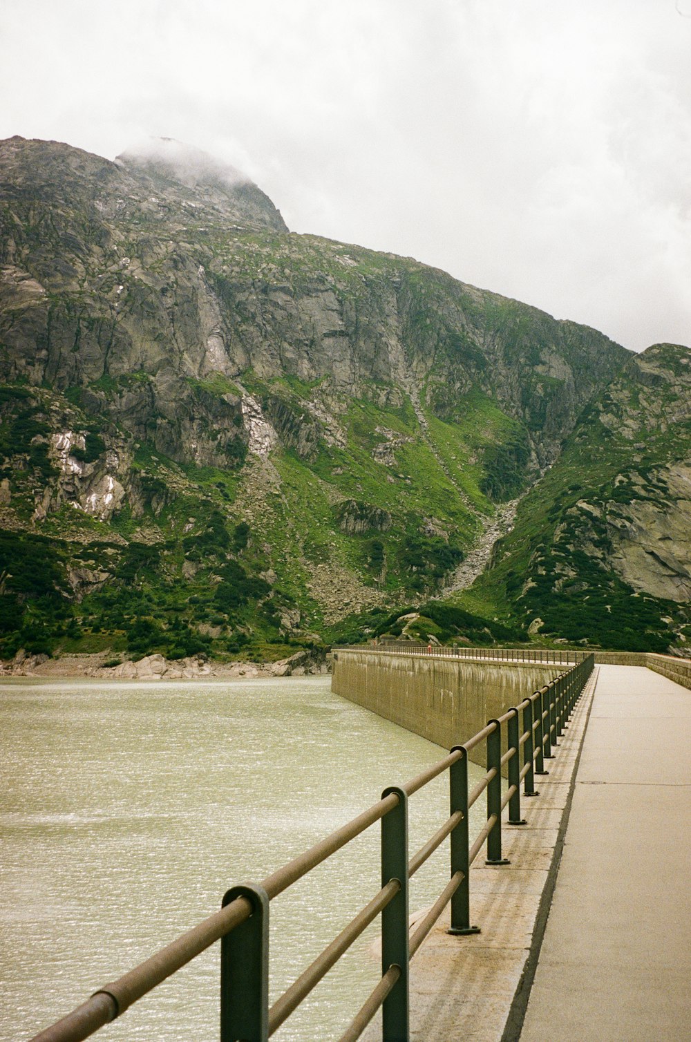 a wooden walkway leading to a large body of water