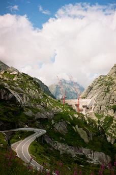 Aerial shot of a highway infrastructure project winding through a mountainous landscape.
