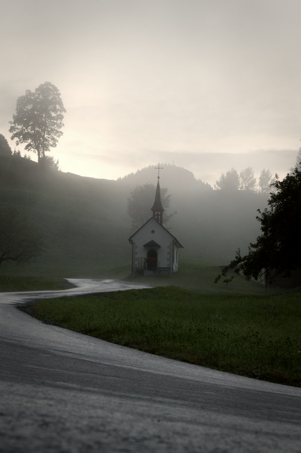 a church in the middle of a rural road