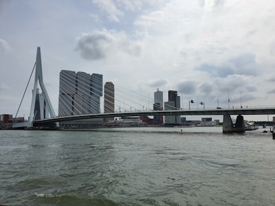 Construction workers building a modern road bridge over a river.