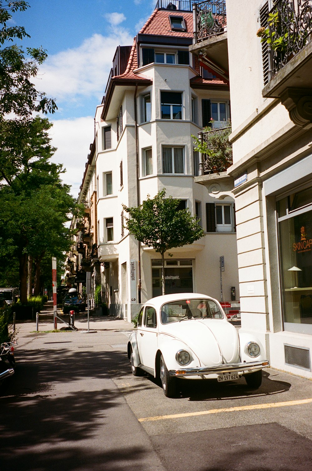 a white car parked on the side of a street