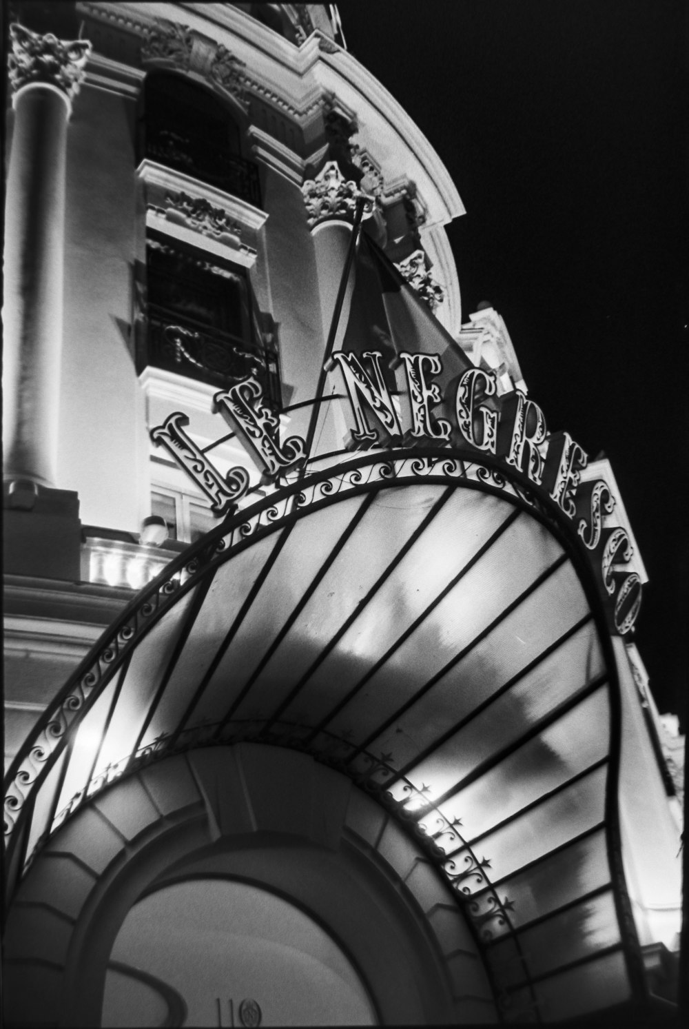 a black and white photo of a theater sign