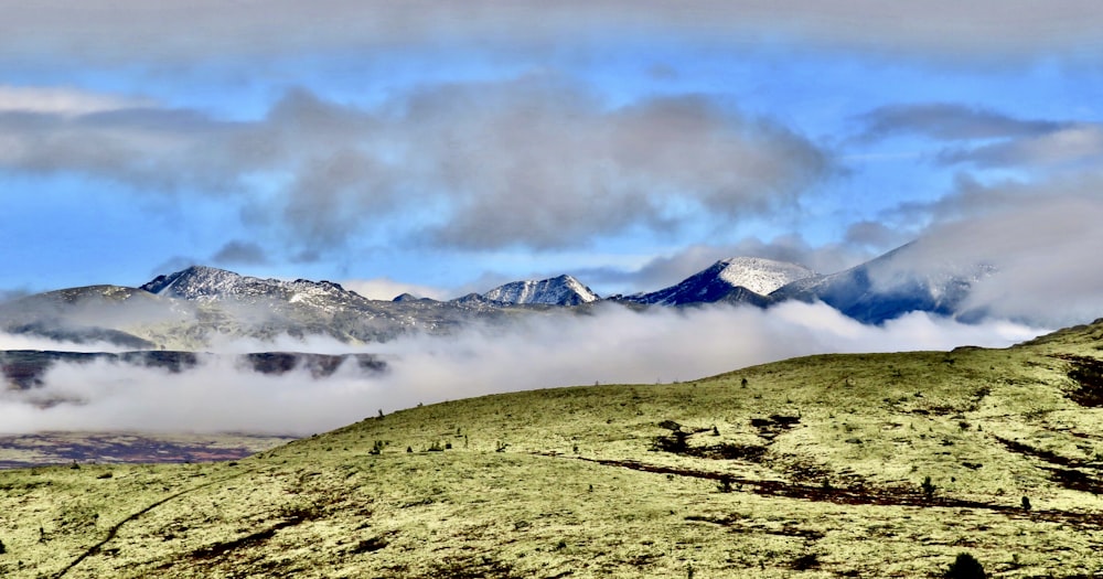 a view of a mountain range covered in clouds