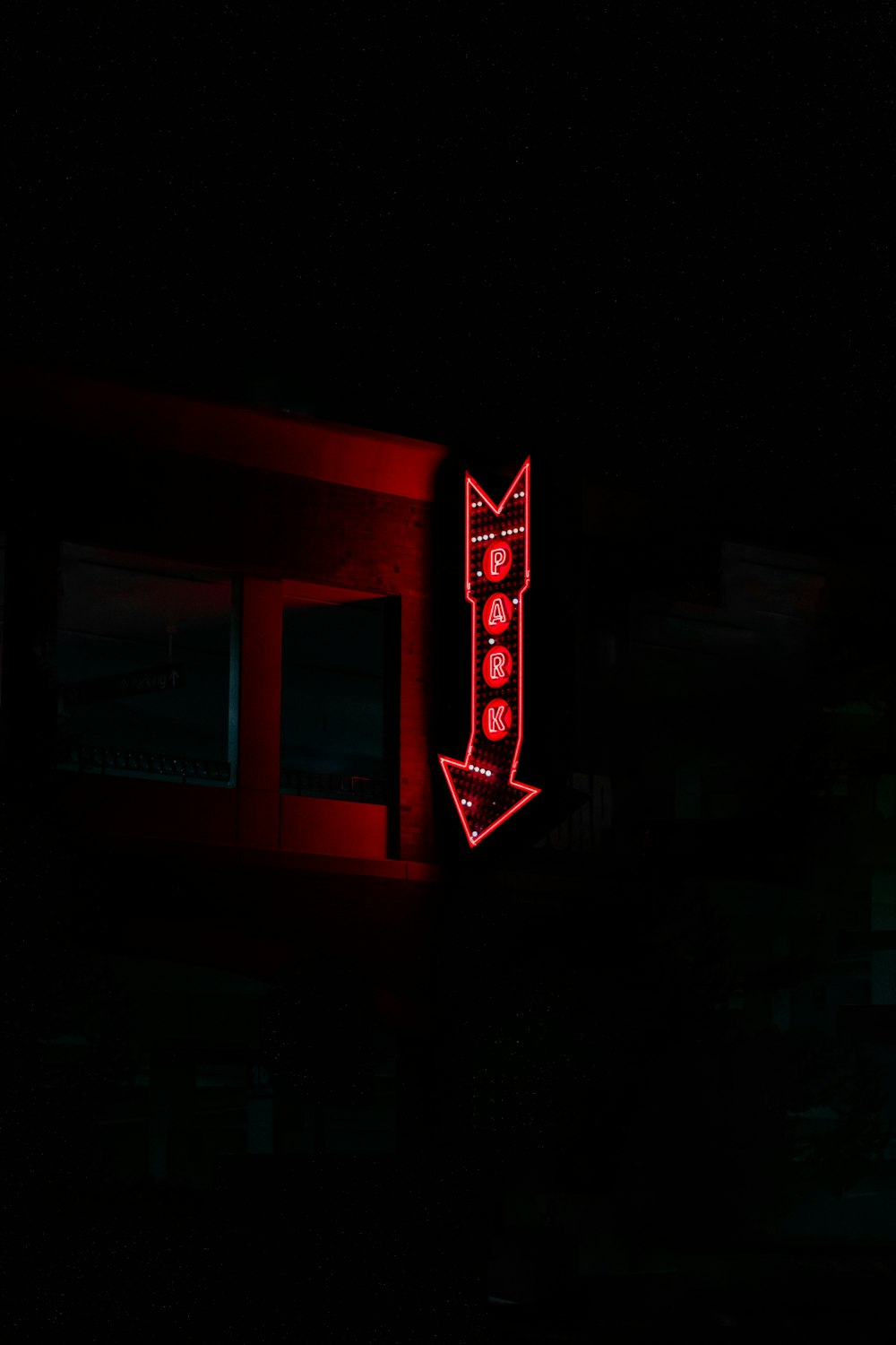 a red neon sign on the side of a building