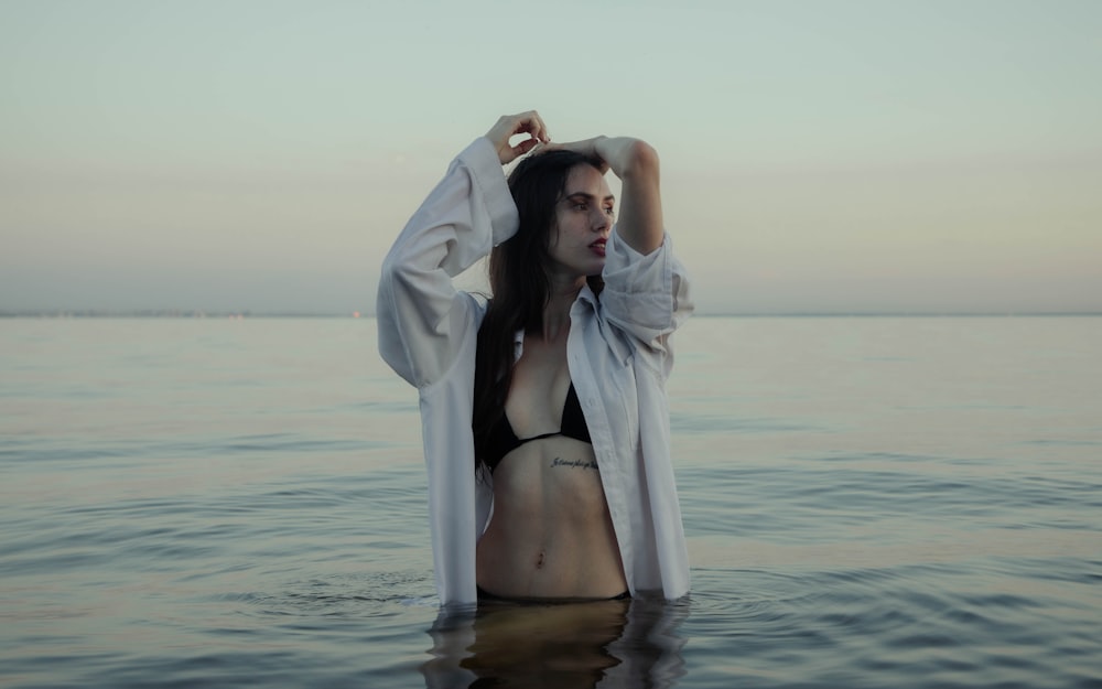 a woman in a bikini standing in the water