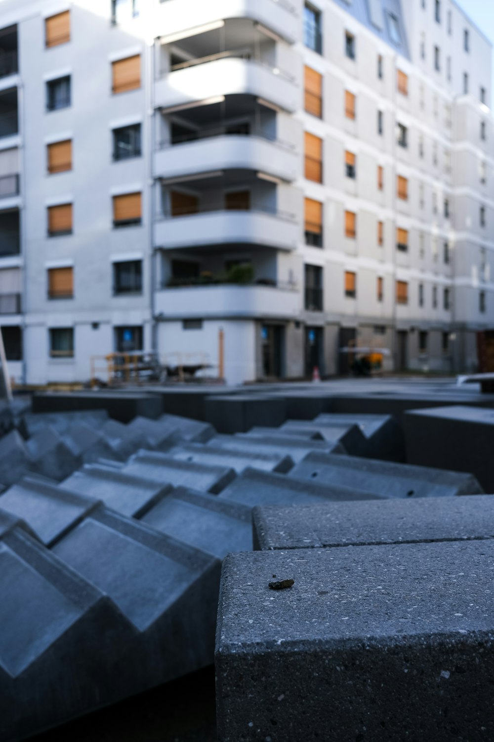 there is a building in the background with a lot of cement blocks in the fore