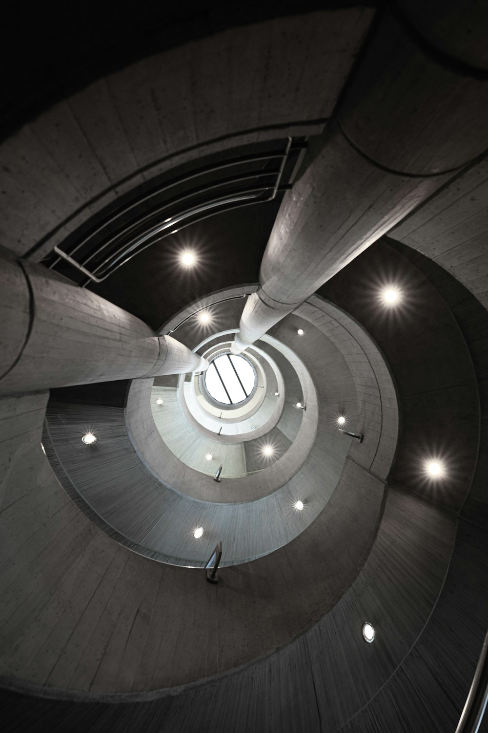 a spiral staircase in a building with lights on