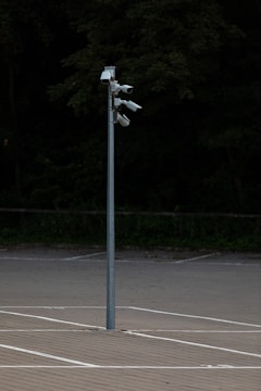 A surveillance camera monitoring a parking lot.