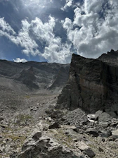 Controlled blasting operation in a rugged mountainous terrain at sunrise.
