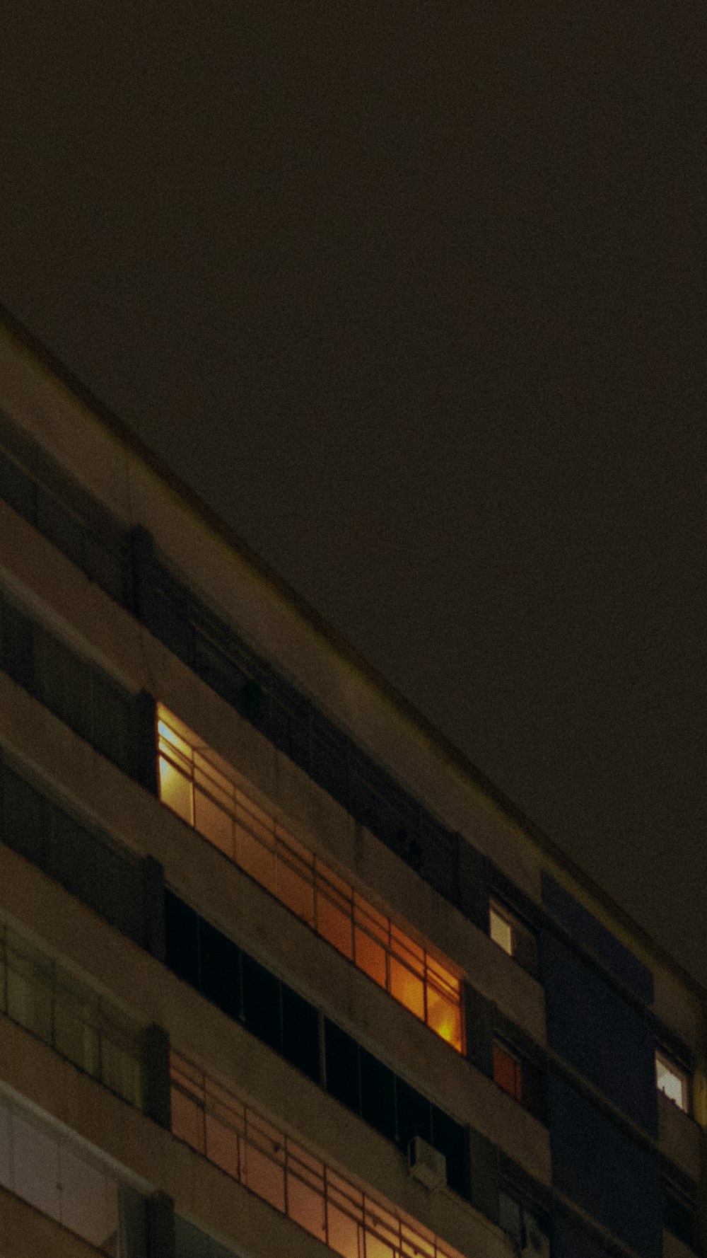 an airplane flying over a building at night