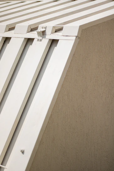 Close-up of elegant wooden louvered shutters on a bright modern home exterior