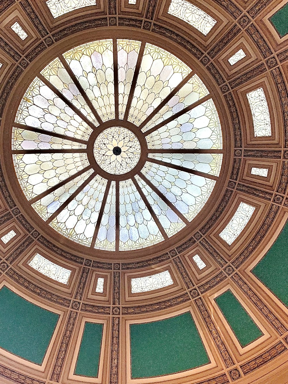 a circular stained glass window in the ceiling of a building