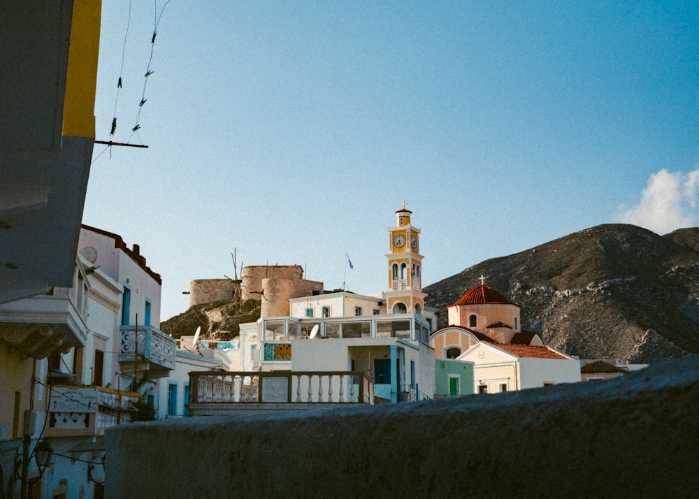 a white building with a yellow clock tower