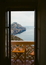 A spacious chalet balcony overlooking Muscat’s scenic mountains at sunset.