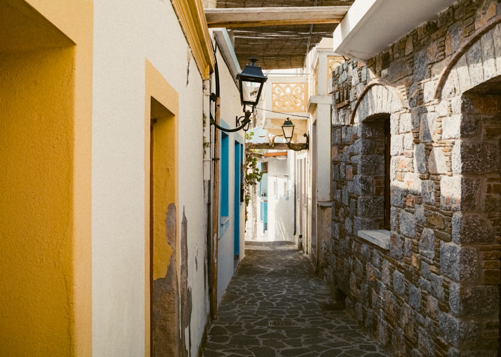 a narrow street with a lamp on the side of it