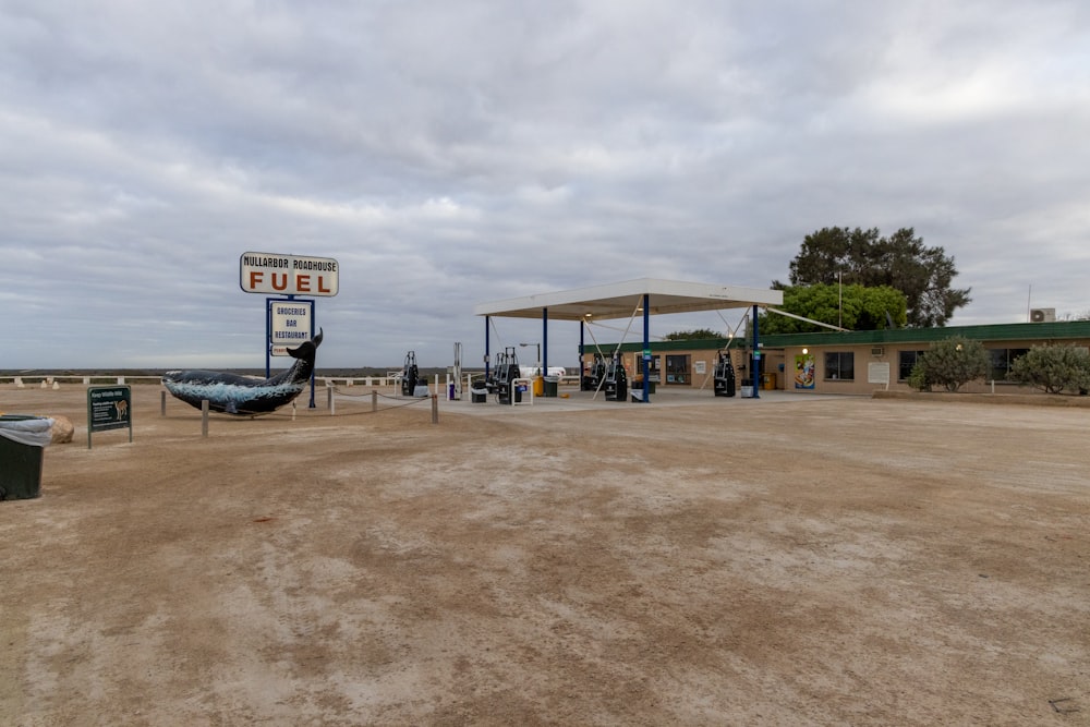 a gas station with a hammock in the foreground