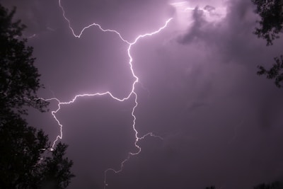 a lightning bolt hitting through a cloudy sky
