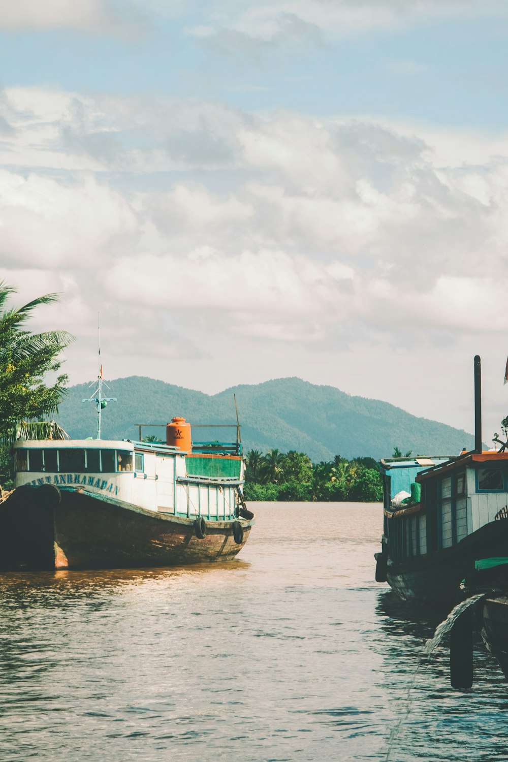 a couple of boats floating on top of a river