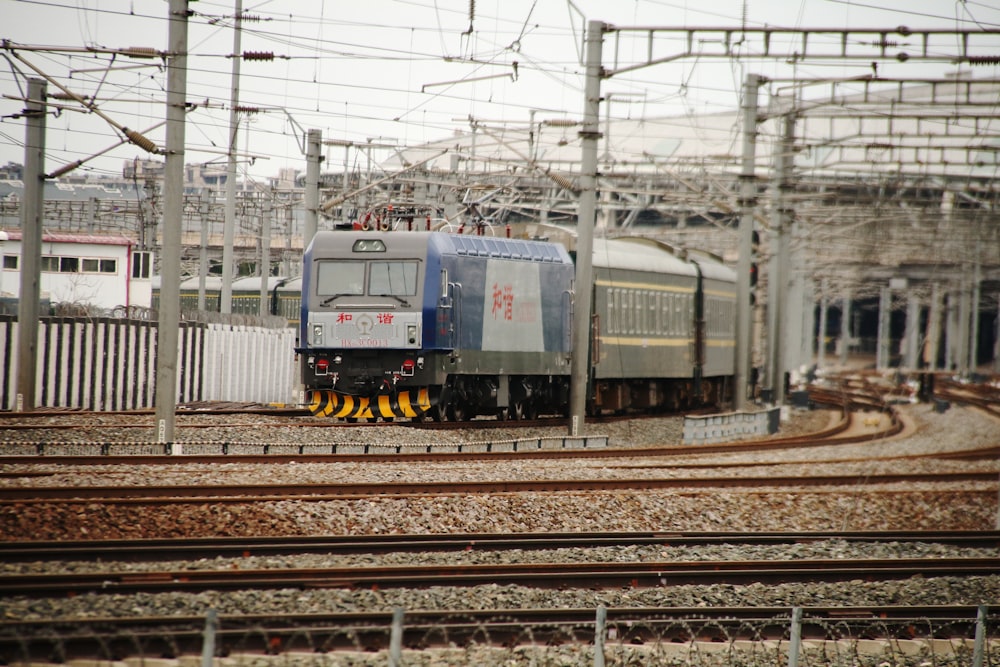 a train traveling down train tracks next to a building