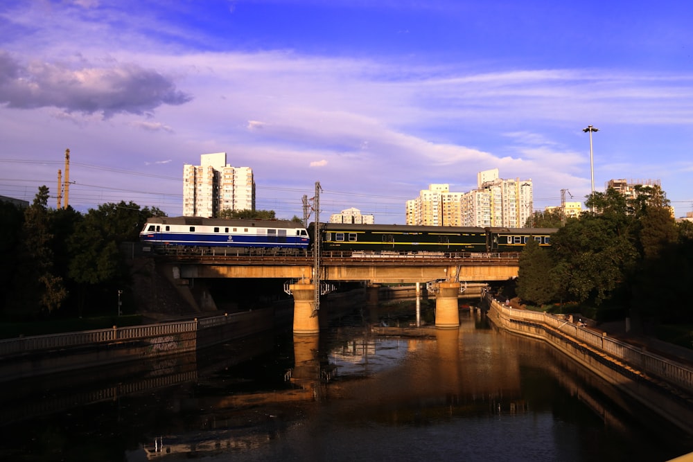 a train traveling over a bridge over a river