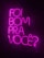 Bright neon pink text is arranged against a dark background, spelling out the phrase 'Foi bom pra você?' in a vertical stack. The vivid color contrasts sharply with the dark surroundings, creating a striking and modern visual.