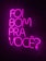 Bright neon pink text is arranged against a dark background, spelling out the phrase 'Foi bom pra você?' in a vertical stack. The vivid color contrasts sharply with the dark surroundings, creating a striking and modern visual.