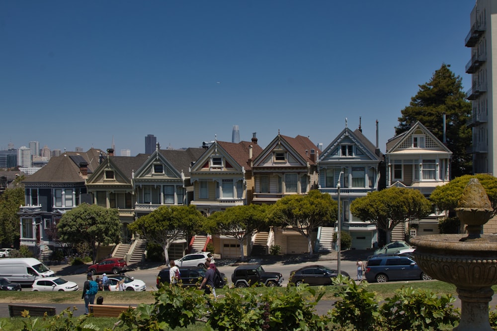 a row of houses with cars parked in front of them