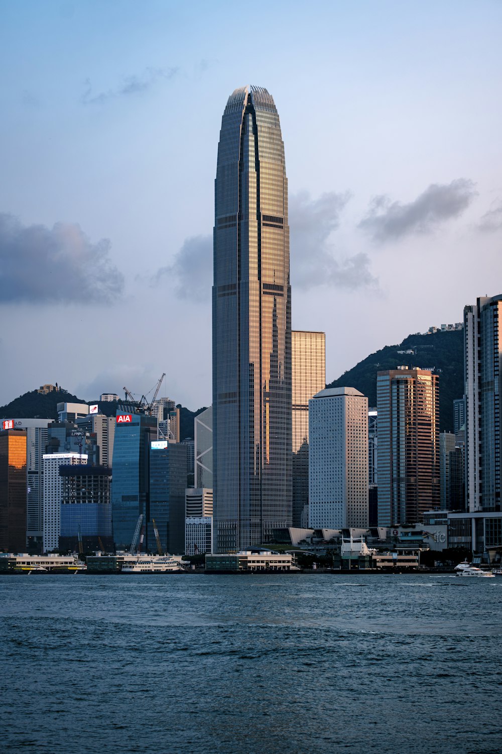 a very tall building sitting in the middle of a body of water