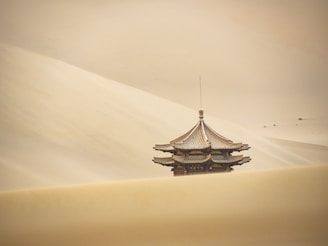 a tall building sitting in the middle of a desert