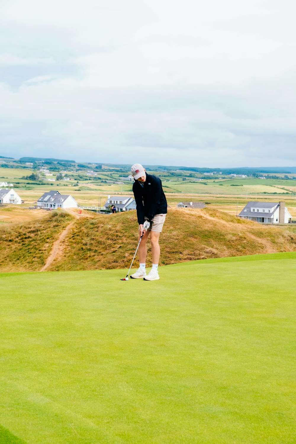 a man playing golf on a golf course