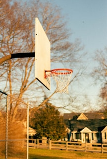 a basketball hoop with a house in the background