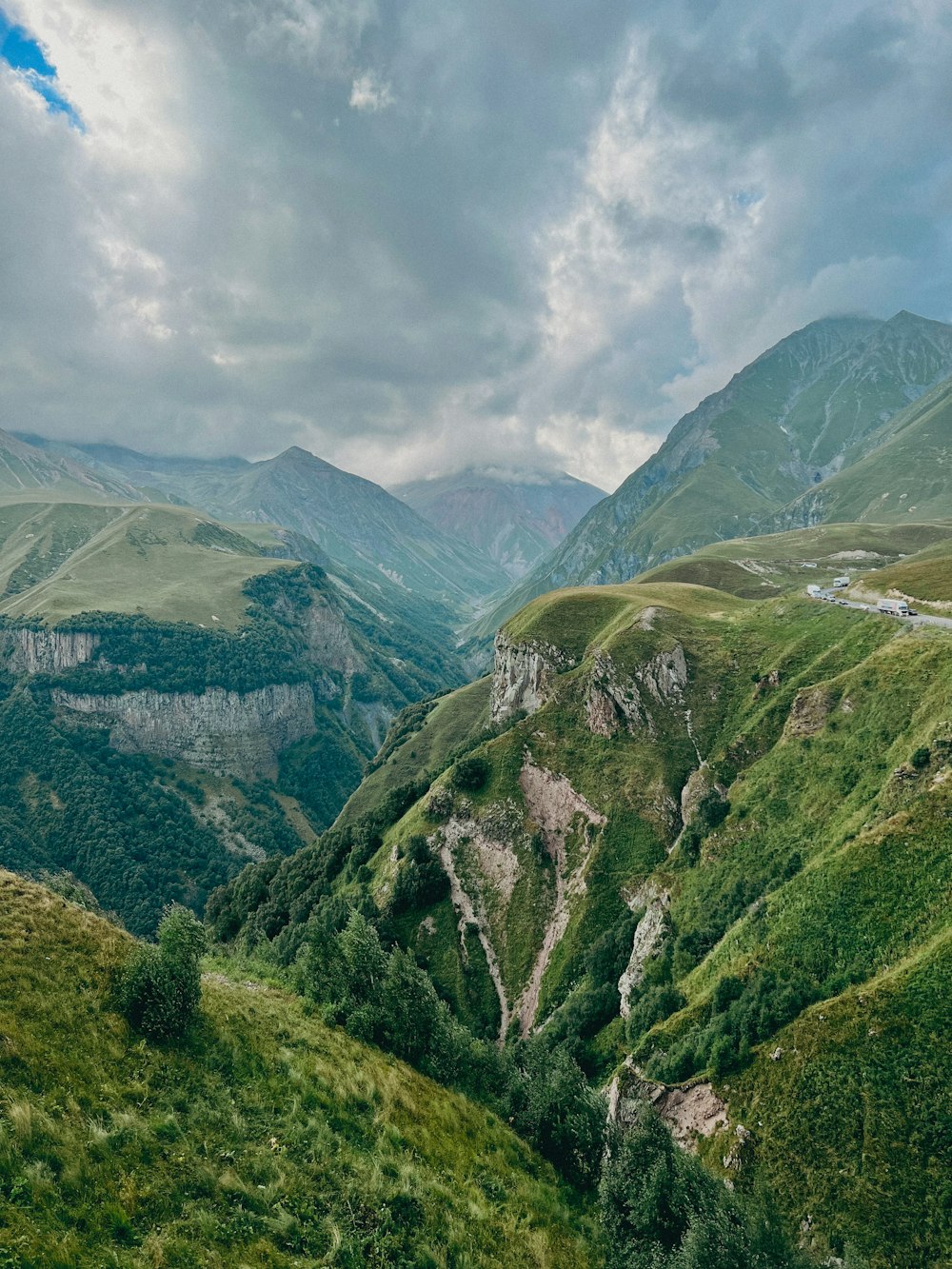 a view of a valley with mountains in the background