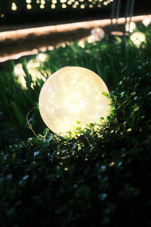 A warm, glowing orb of light surrounded by delicate green and blue hues, evoking a safe womb-like embrace.