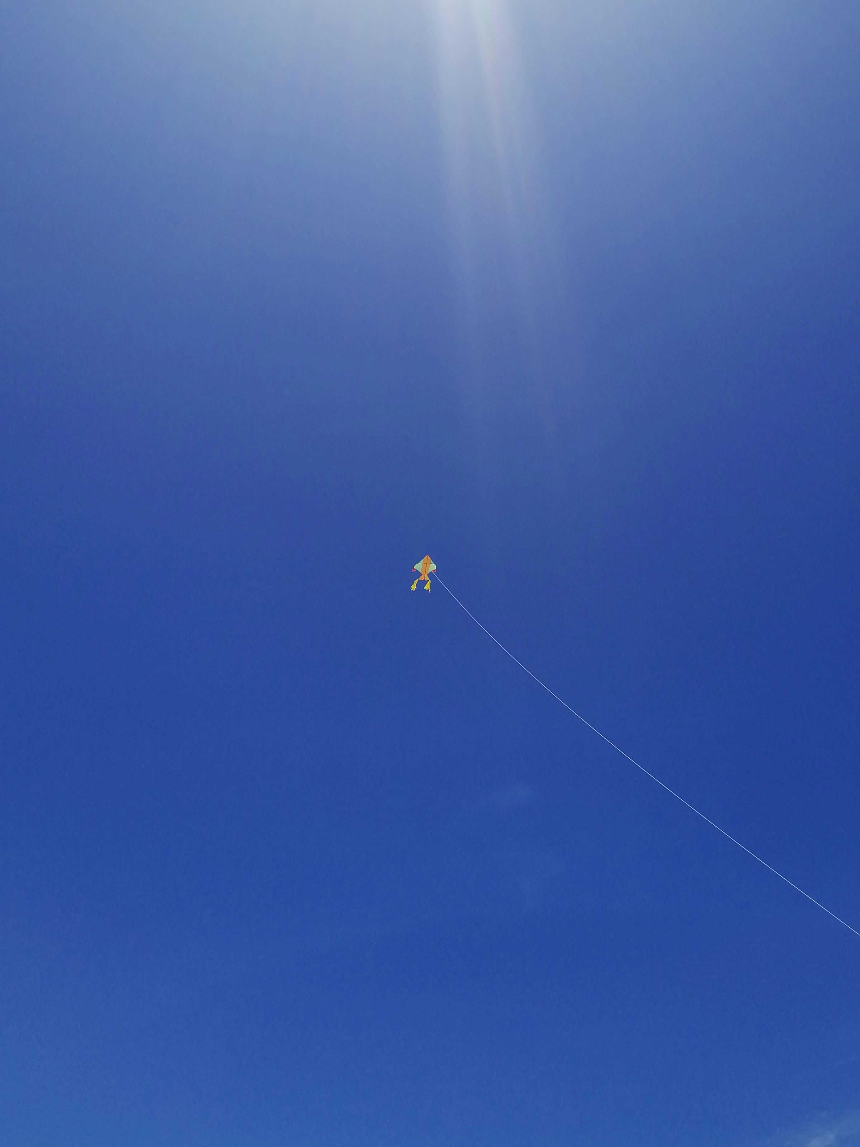 a person flying a kite on a sunny day