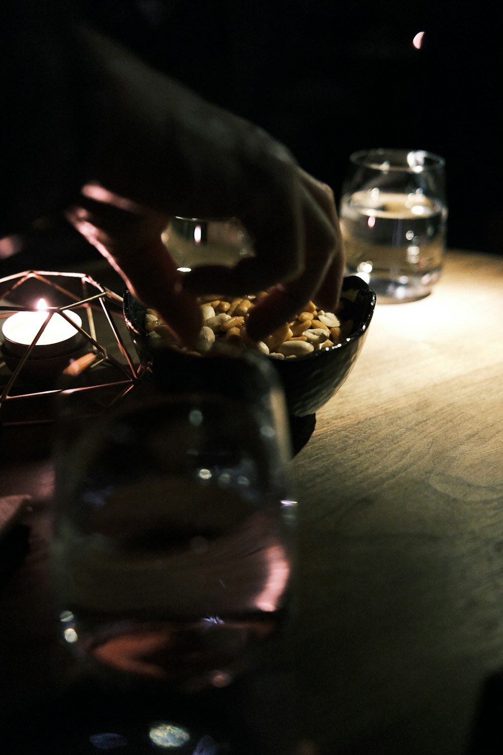 a person is lighting a candle in a bowl of food