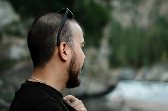 a man with a beard and sunglasses on his head