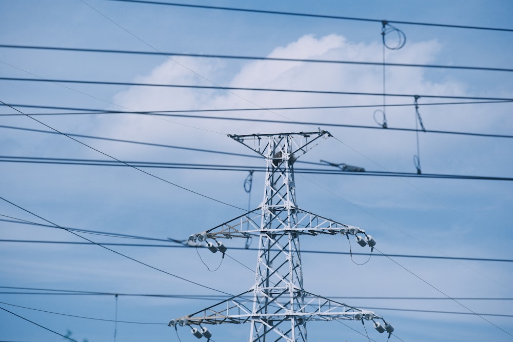 a high voltage power line with a blue sky in the background