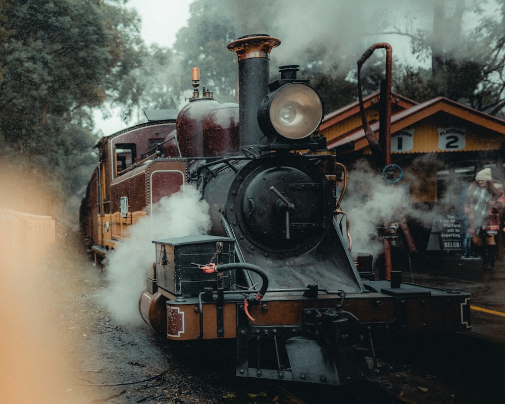 a steam engine train traveling down train tracks