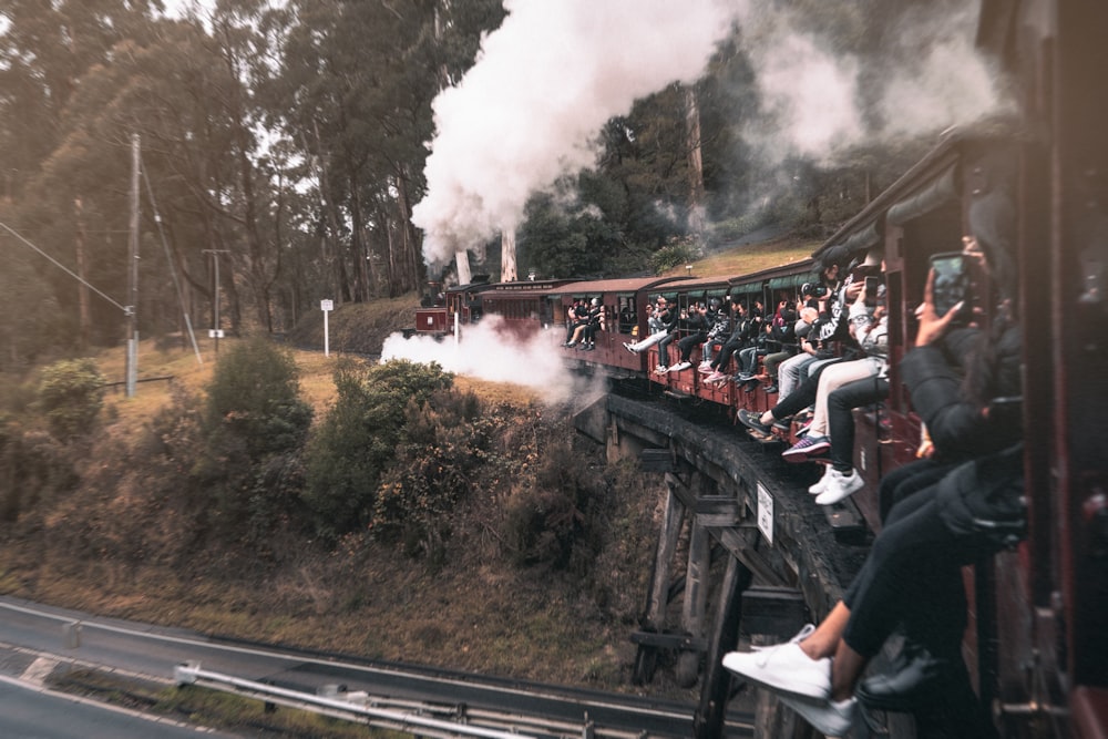 a group of people riding on the back of a train