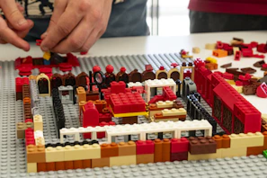 Hands carefully sorting through a collection of authentic LEGO® parts, emphasizing trust and care