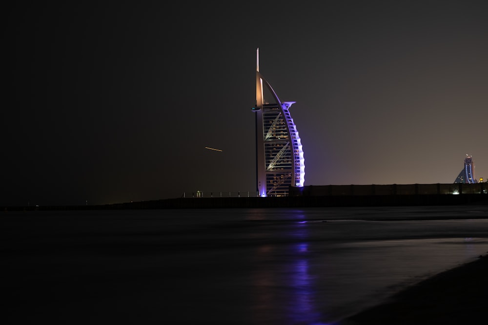 a very tall building sitting in the middle of a body of water