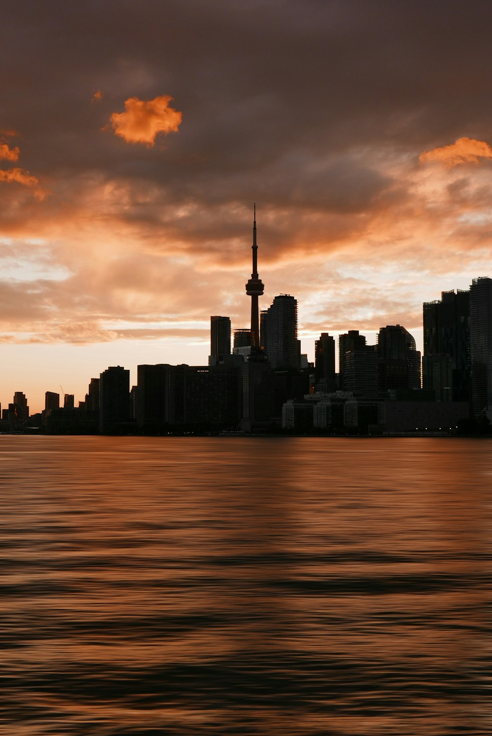 a large body of water with a city in the background