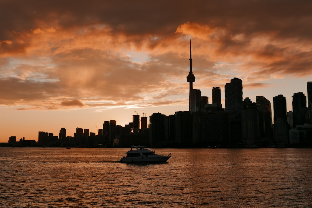 a boat in a body of water with a city in the background