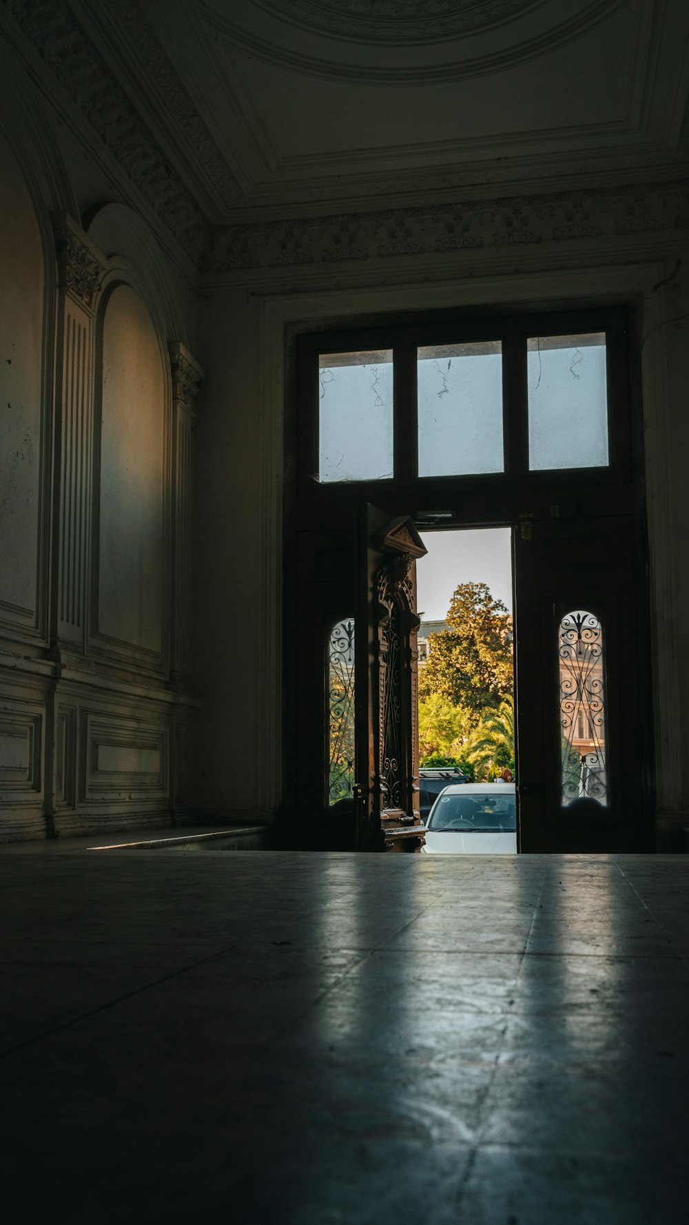 an open door in a large room with a clock on the wall