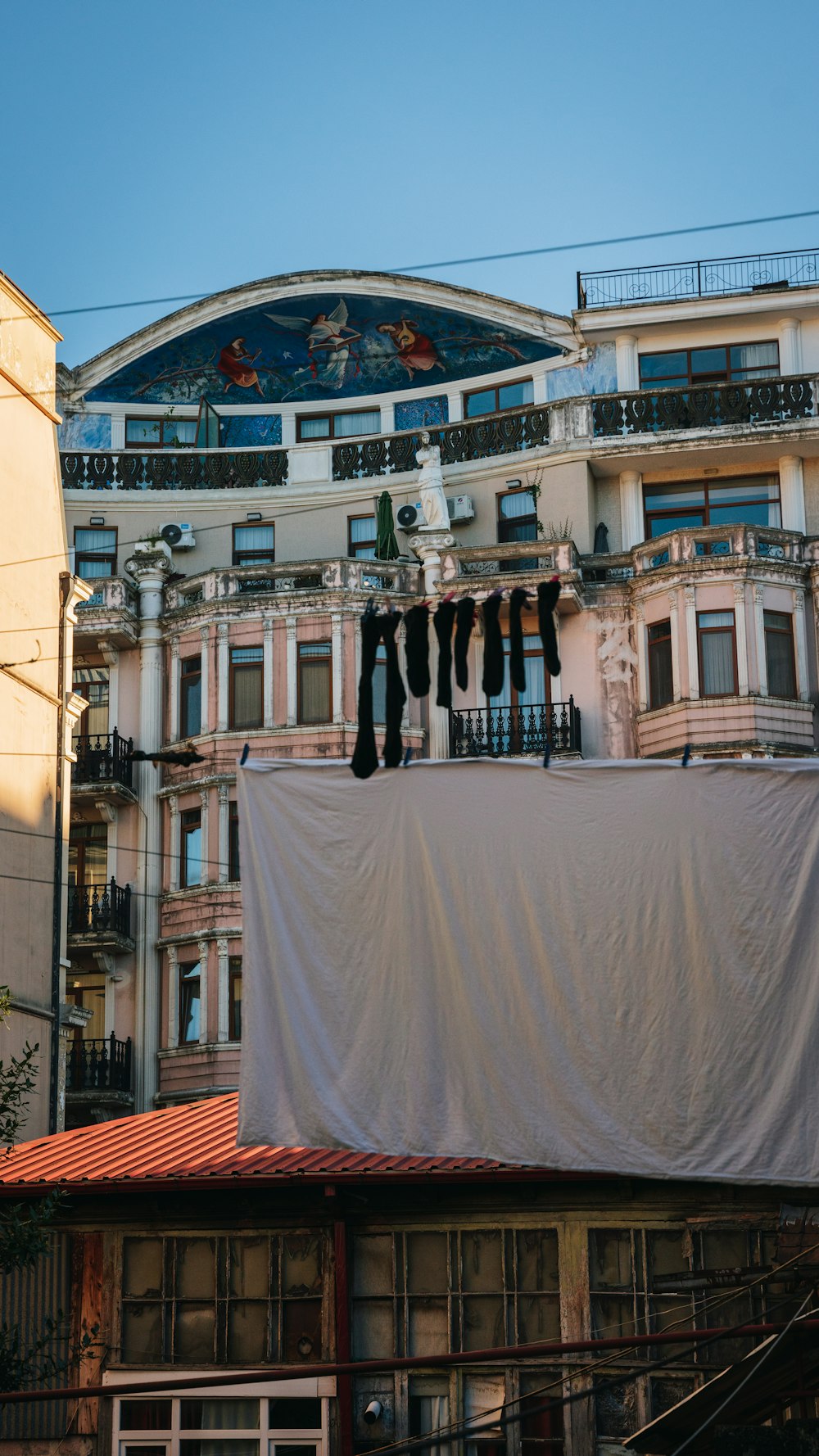 clothes hanging on a clothes line in front of a building