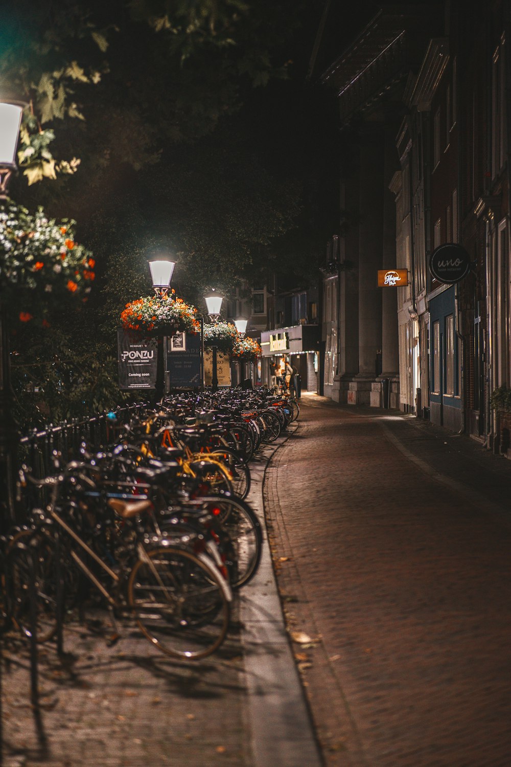 a row of bicycles parked on the side of a street