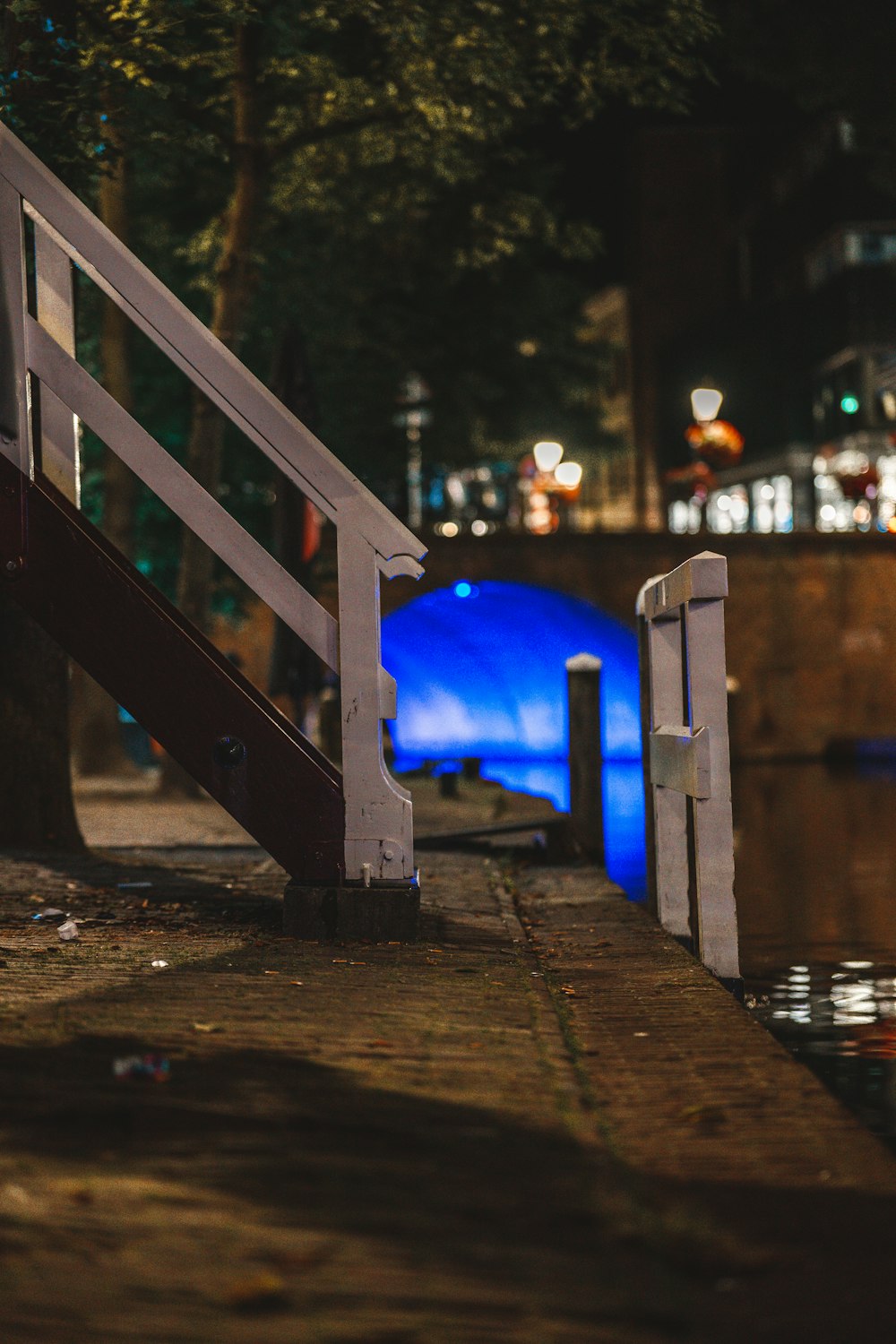 a wooden railing next to a body of water